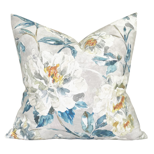 a dreamy floral printed pillow in an illustrated style. Blue and orange hues