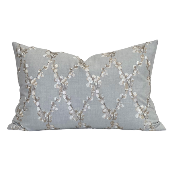 Embroidered floral blue pillow with linen fabric background