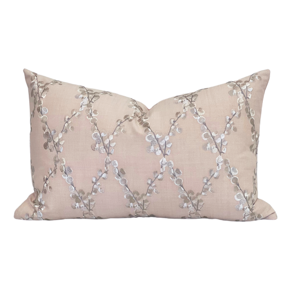 Embroidered floral pink pillow with linen fabric background